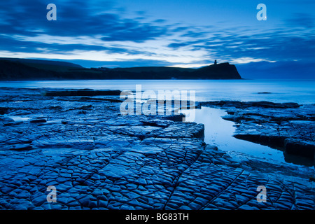 Dawn at Kimmeridge Bay, Dorset with Clavell Tower in the distance Stock Photo