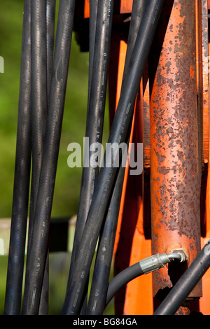 Close-up of hydraulic hoses and fittings on farm machinery, displaying ...