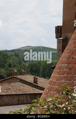 Clay tiled roofs and views of the vineyards around Barolo castle Langhe Piedmont Italy
