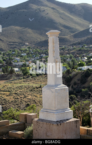 Tombstone at Silver Terrace Cemeteries, circa 1800s. Virginia City, Nevada. Town in the background. Stock Photo