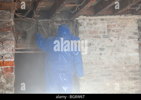 A workman working on a flood damaged shop in Cockermouth Stock Photo