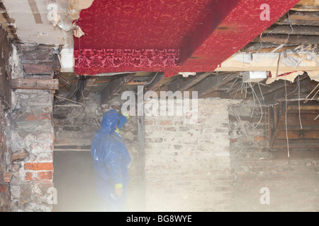 A workman working on a flood damaged shop in Cockermouth Stock Photo
