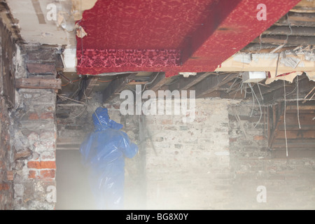 A workman working on a flood damaged shop in Cockermouth Stock Photo