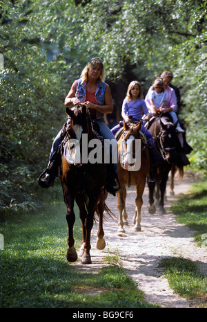 Family of horse riders on a wooded trail Stock Photo - Alamy