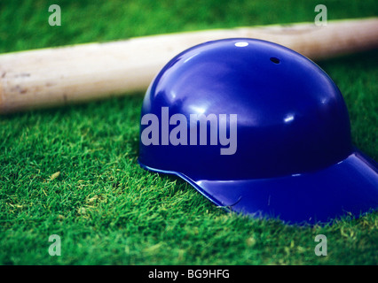 Close up of baseball bat and helmet on pitch Stock Photo