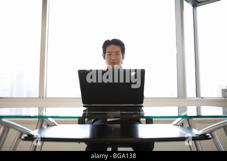 Mature man looking at computer monitor Stock Photo