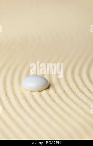 White muddy drop on a surface of yellow sand Stock Photo