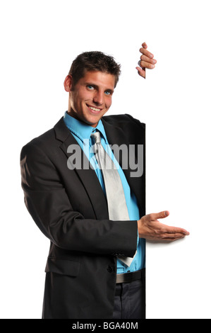 Young businessman holding a blank sign and smiling on a white background Stock Photo