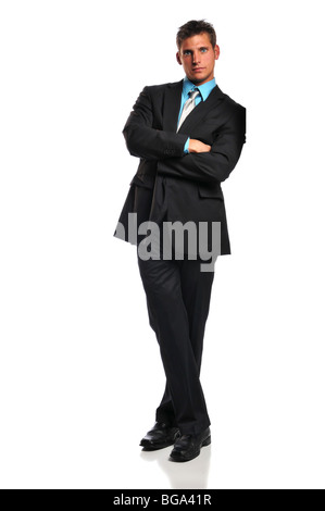 Young businessman leaning against a white wall Stock Photo