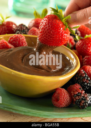 Strawberry dipping in chocolate sauce Stock Photo