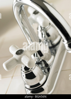 Bathroom faucet on tile counter Stock Photo