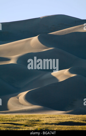 Sand moved by wind collects up against the Rocky Mountains forming Great Sand Dunes National Park, Colorado Stock Photo
