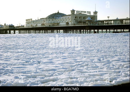 Heavy snow on brighton beach with the pier in the background Stock Photo