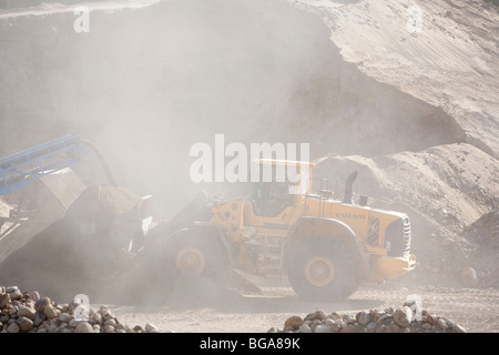 Front loader moving sand in a sandpit at sand quarrying area , Finland Stock Photo