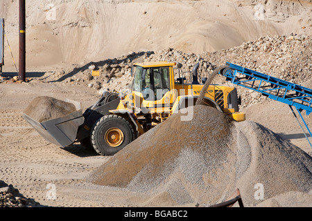 Front loader moving sand in a sandpit  at sand quarrying area, Finland Stock Photo
