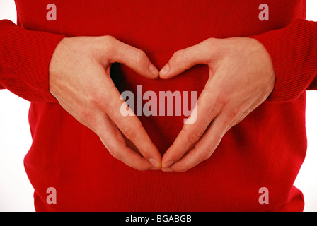 Young man making heart shape with hands Stock Photo