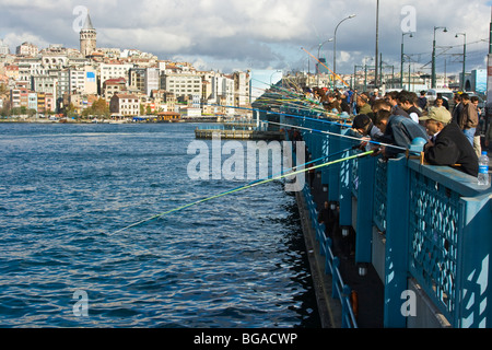Locals Fishing off of the Galata Bridge in Istanbul Turkey Stock Photo