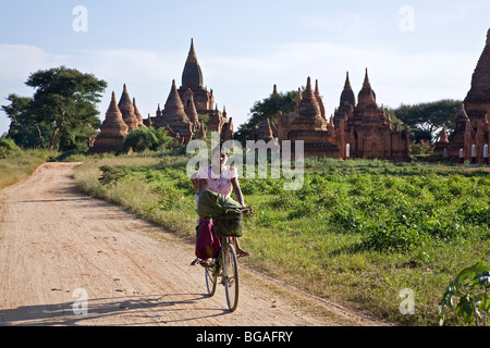 Burmese woman cycling. Bagan. Myanmar Stock Photo
