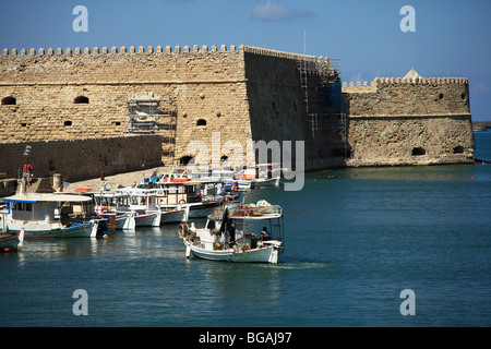 A fishing boat sets out for the evening s work from the harbour at Iraklion, Crete Stock Photo