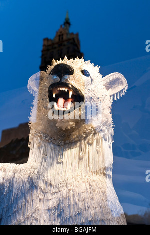 a menacing but magical polar bear wearing crystal mask in a Bergdorf Goodman Christmas window refecting the Sherry Netherland Stock Photo