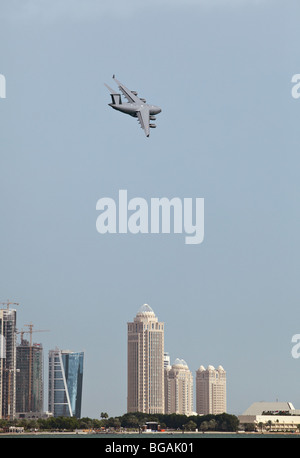 One of the Qatar Emiri Air Force's two new C-17 Globemaster III heavy transport aircraft over the hotels area of Doha as part of Stock Photo