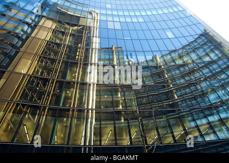 The Lloyds Building designed by Sir Richard Rogers in London reflected in the windows of a nearby office building Stock Photo
