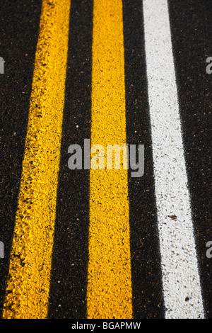 Yellow and white road markings. Stock Photo