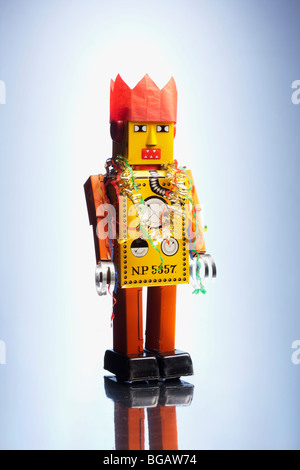 Tinplate robot stands in party hat with streamers Stock Photo
