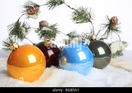 Colorful christmas ornaments on fake snow shot in studio Stock Photo