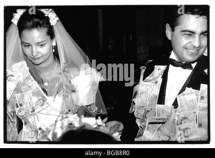 Religion Christian Weddings Traditional Greek Wedding Ceremony. Bride And Groom Covered In Money That Has Been Pinned To Them. Stock Photo