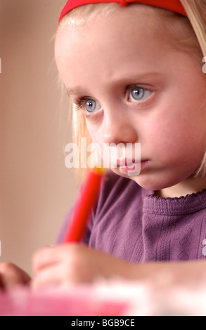 Royalty free photograph of child girl enjoying arts and crafts lesson in nursery school early learning UK Stock Photo