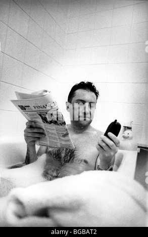 Photograph of business man bath checking hare prices investments Stock Photo