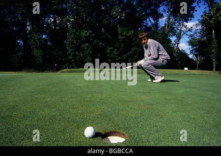 Golfer disappointed the ball did not go in the hole Stock Photo