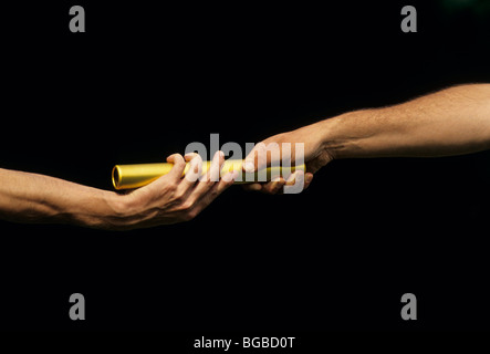 Two athletes passing a baton Stock Photo