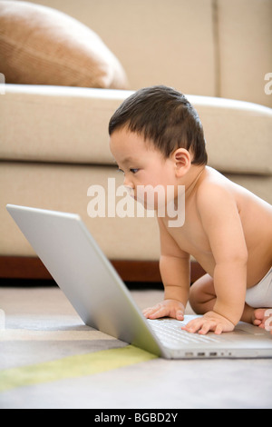Infant with laptop Stock Photo