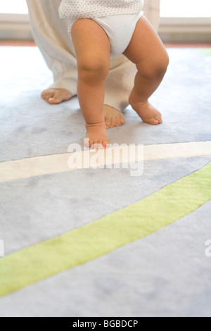 Mother and baby legs. First steps Stock Photo - Alamy