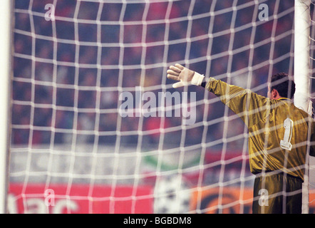 Goalkeeper in the goal directing the wall formation for a free kick Stock Photo