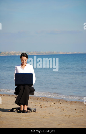 Young female office worker on the beach Stock Photo