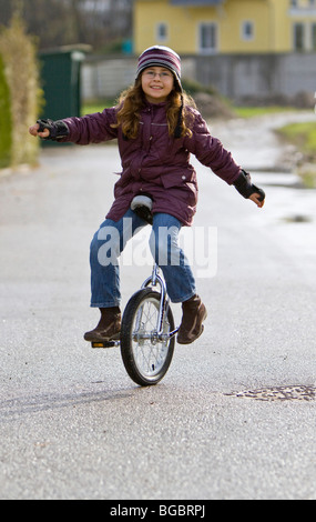 Girl, nine years, unicycling Stock Photo
