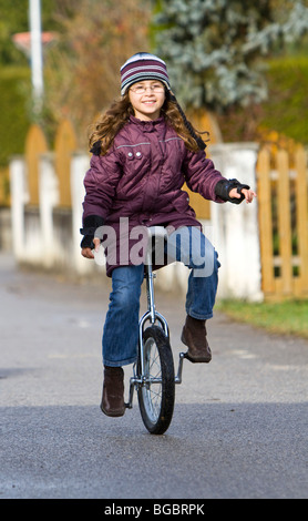 Girl, nine years, unicycling Stock Photo