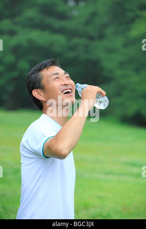 Mature man drinking water Stock Photo