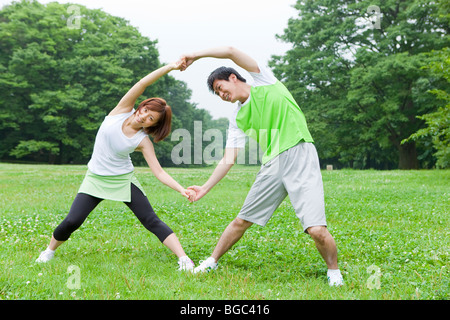 Young man and woman stretching Stock Photo