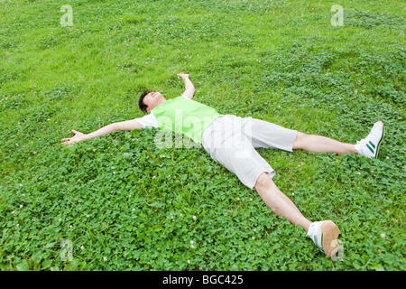 Young man lying on grass Stock Photo