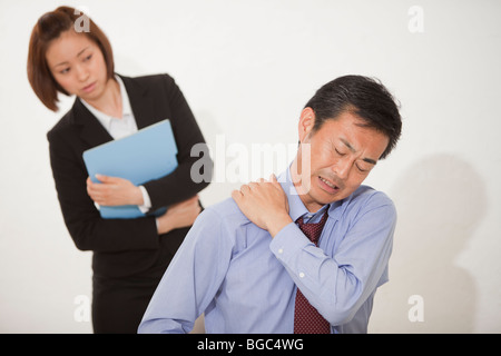 Young woman looking exhausted mature man Stock Photo
