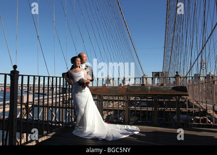 couple in wedding clothes on brooklyn bridge, new york city