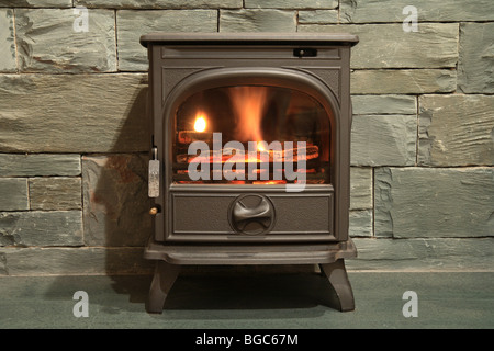 'Wood burning stove' standing on a Slate hearth with a slate surround, fireplace Stock Photo