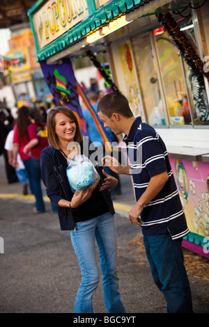 A couple eats cotton candy at the South Carolina Coastal Fair in Charleston, SC. Stock Photo