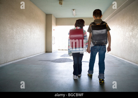 Boy and girl walking hallway Stock Photo