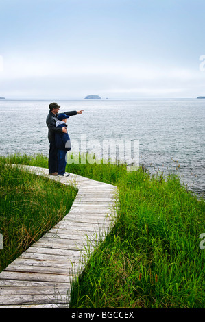 Father and son standing at Atlantic shore in Newfoundland, Canada Stock Photo