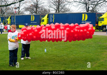 Boys with red balloons at the start of the London marathon. Stock Photo